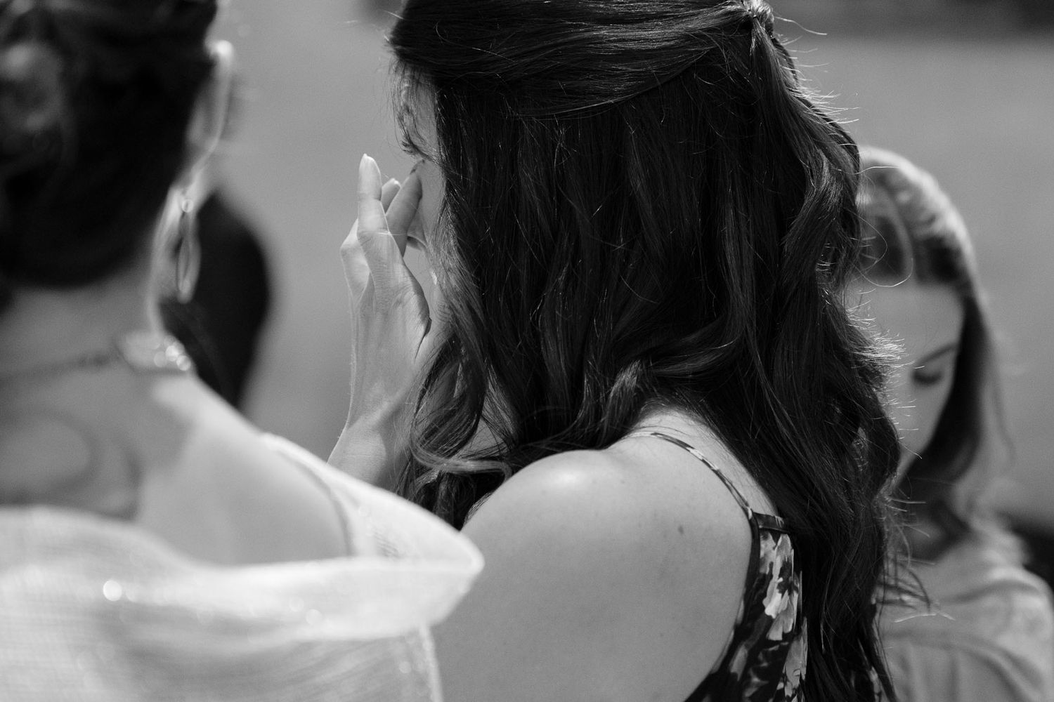 A close-up black and white view of delicate wedding hair accessories and styling.