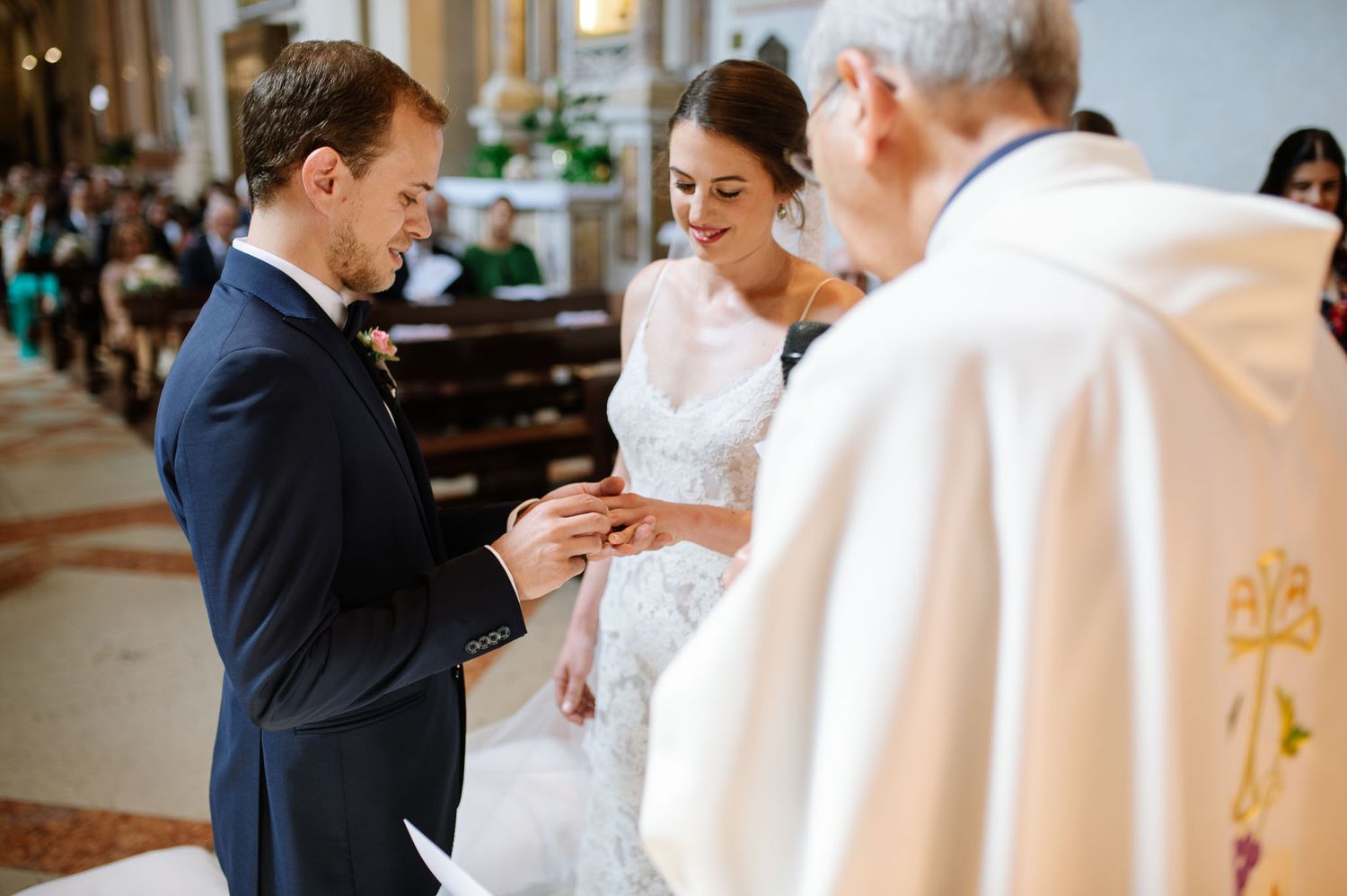 The exchange of rings between newlyweds during a traditional church ceremony.
