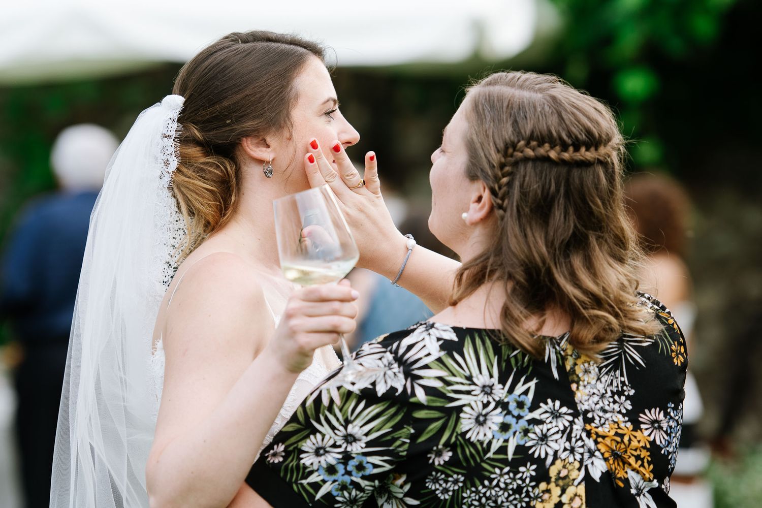 Two attendees sharing an emotional moment during the wedding celebration.