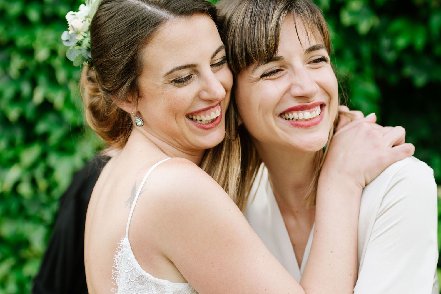 Candid moment of shared laughter and joy at a wedding celebration.