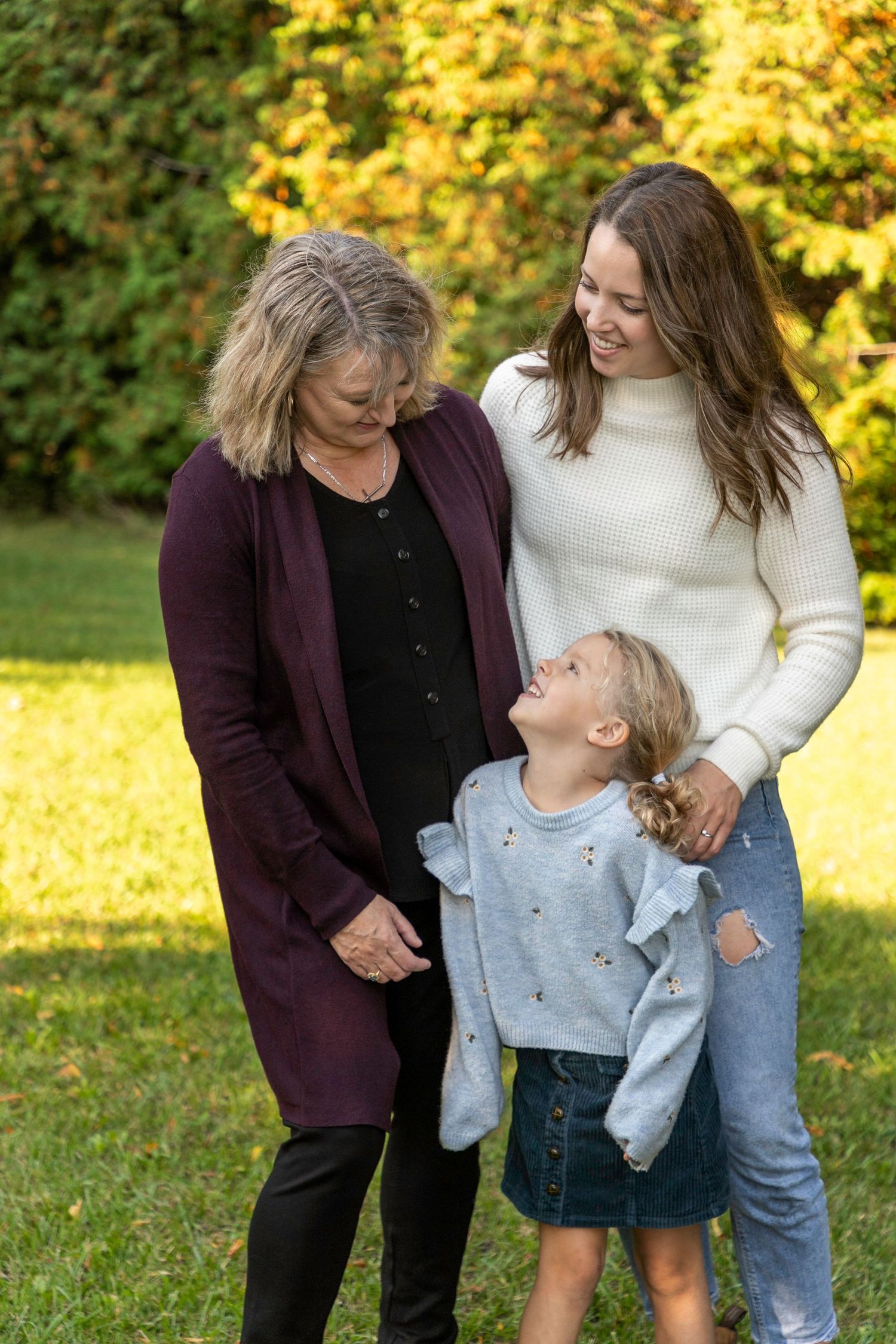 3 generations of women (one being a kid) looking at one another
