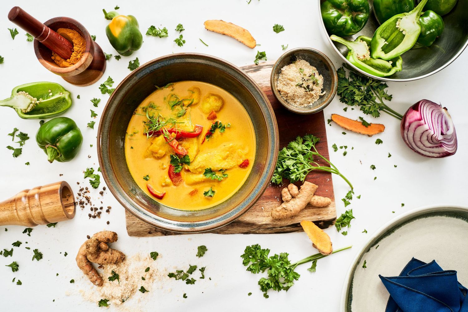 Colorful food photography layout featuring soups, vegetables and garnishes.