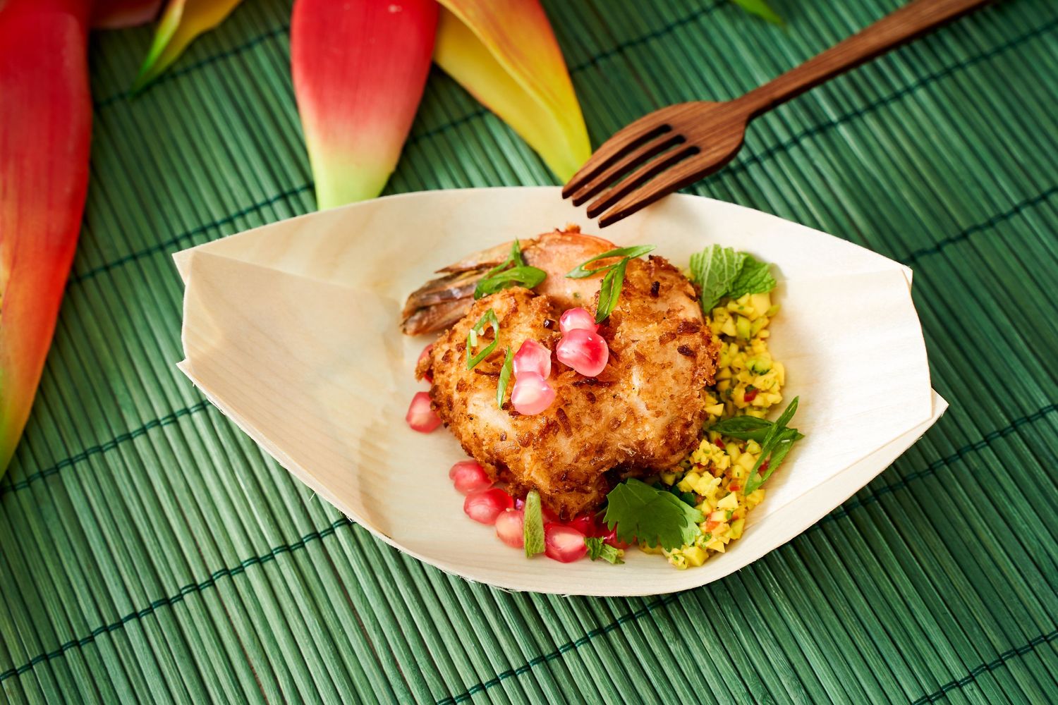 Asian-inspired dish with colorful garnishes served on bamboo mat.
