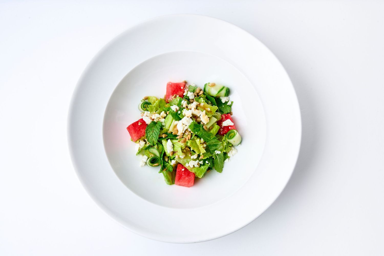Minimalist plating progression of small portions on white dishes.