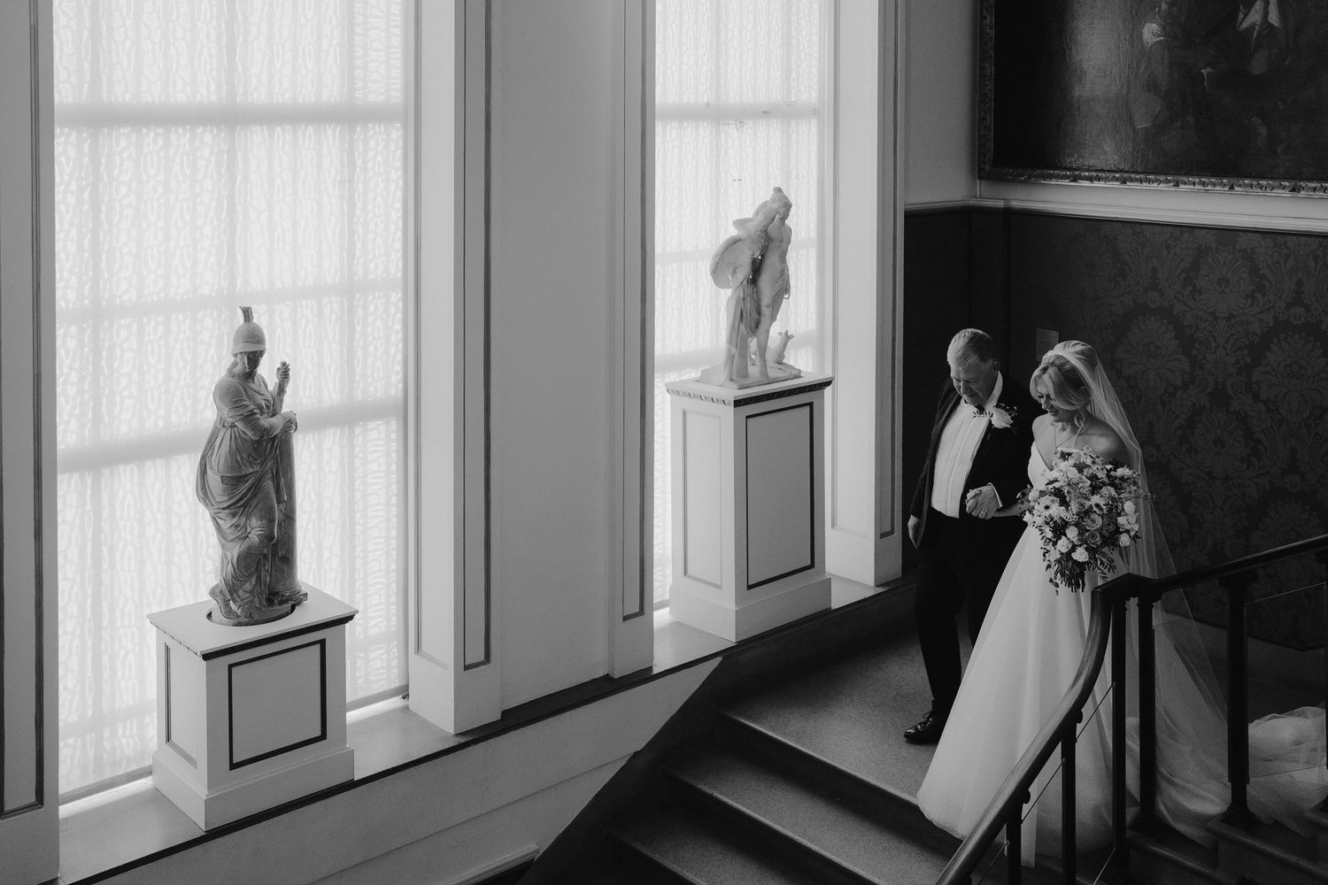 bride and groom descending stairs at the European art gallery to meet the groom at the alter at the ashmolean museum