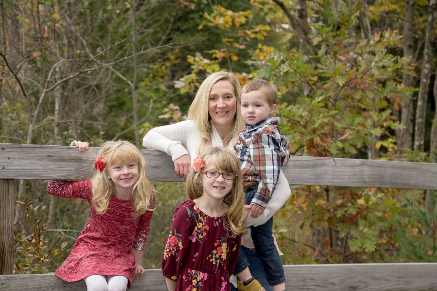 Family standing in front of fence, family photography