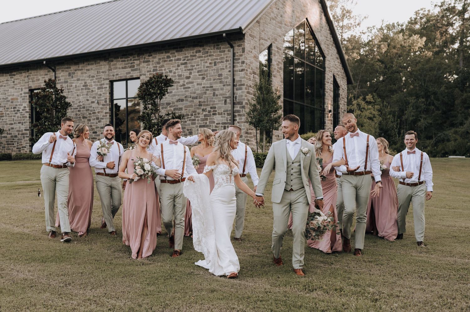 Bride, groom, and wedding party walking together at the Luminaire in Montgomery, Tx.