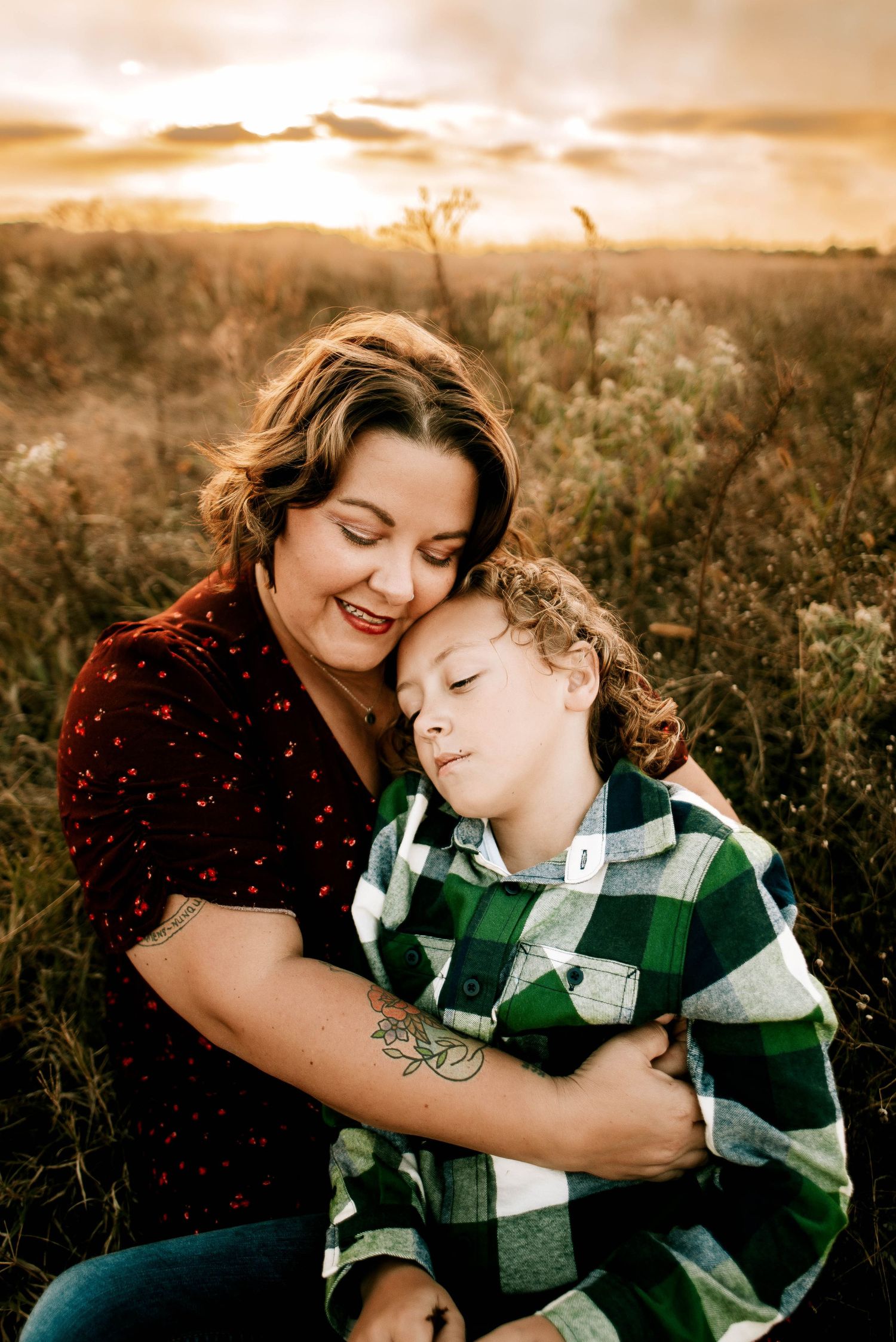 A tender moment captured between parent and child in a sunlit field at golden hour.