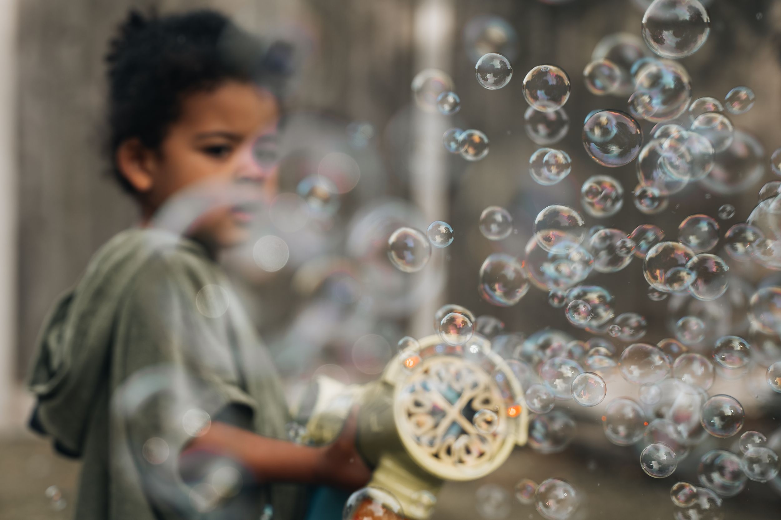 Delicate soap bubbles floating across the frame with a soft, dreamy background.