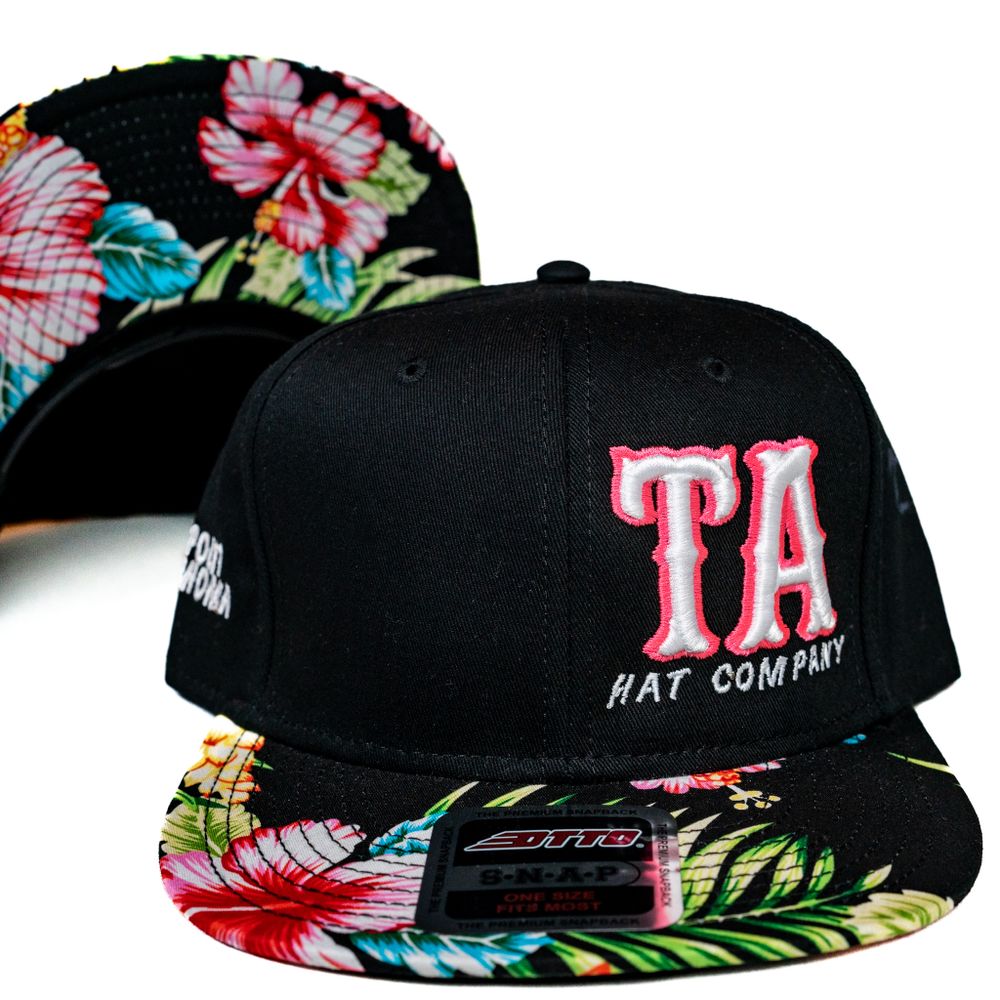 Black snapback hat with floral brim featuring 'TA' embroidered logo.