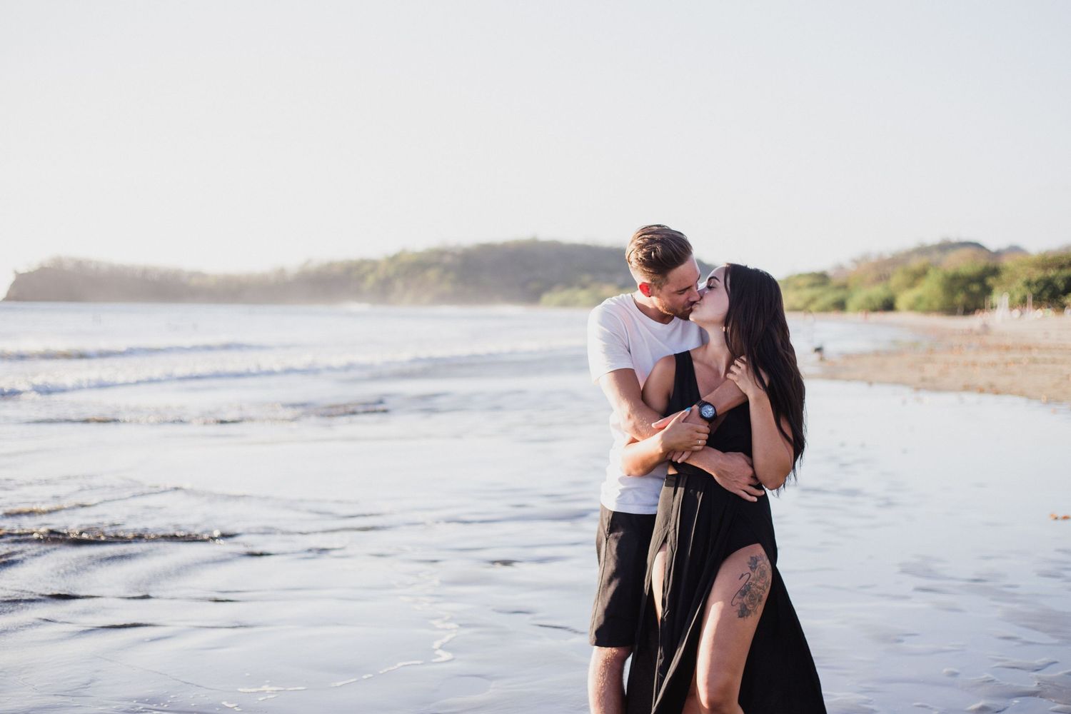 Engaged couple kiss on a beach in Nicaragua
