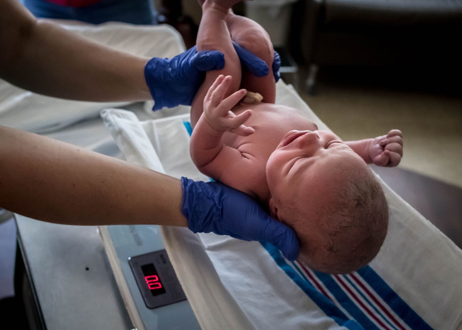 Newborn baby girl being weighed by the nurse at Mercy Medical Center in Sioux City, IA.
