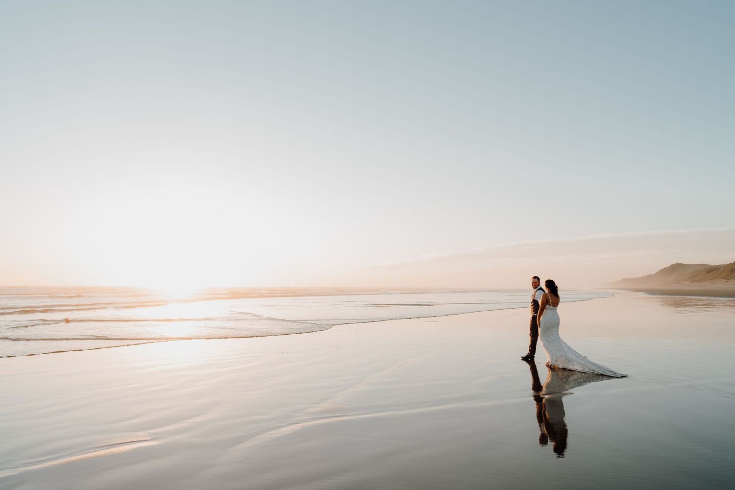 Wedding couple walking along the beach