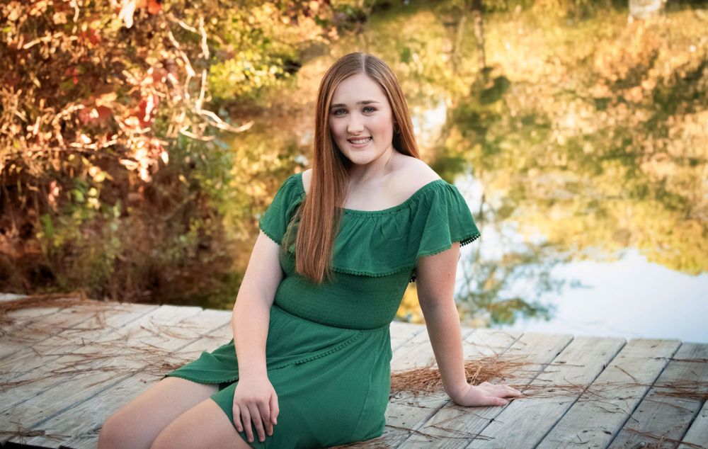 A series of outdoor portrait photos in autumn with green clothing and fall foliage in the background.