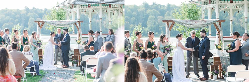 Wide view of outdoor wedding ceremony with guests seated under blue and white decorations.