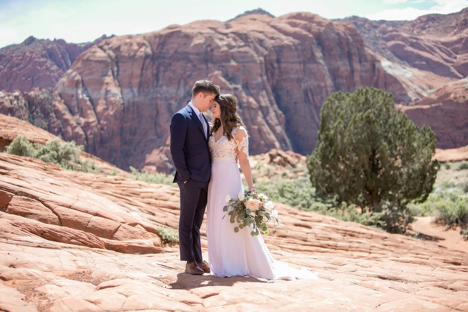 Bride and groom on the petrified dunes at Snow Canyon State Park during Utah adventure destination wedding