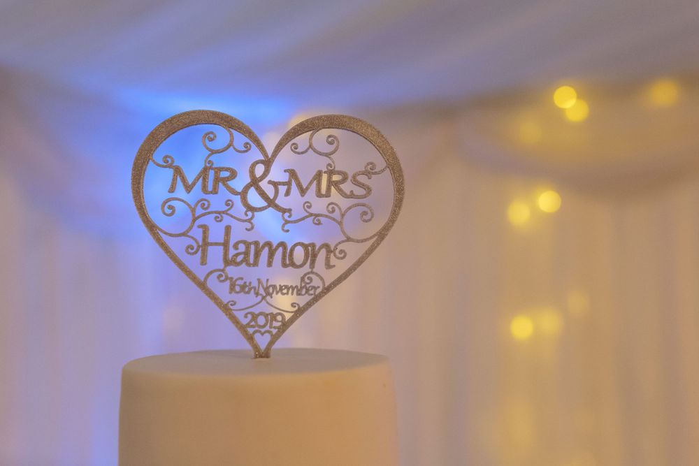 mr and Mrs Hamon take topper sits proudly on top of the wedding cake