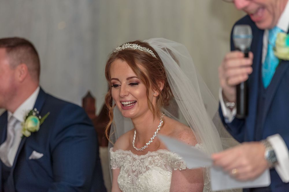 bride laughs during her fathers wedding speech