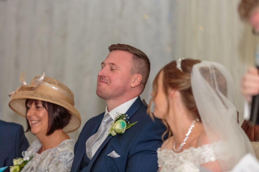 groom with his head back and eyes closed during the wedding speeches