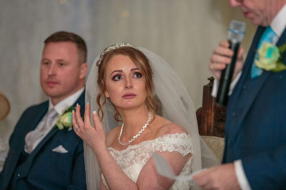 bride looking upset during her fathers wedding speech