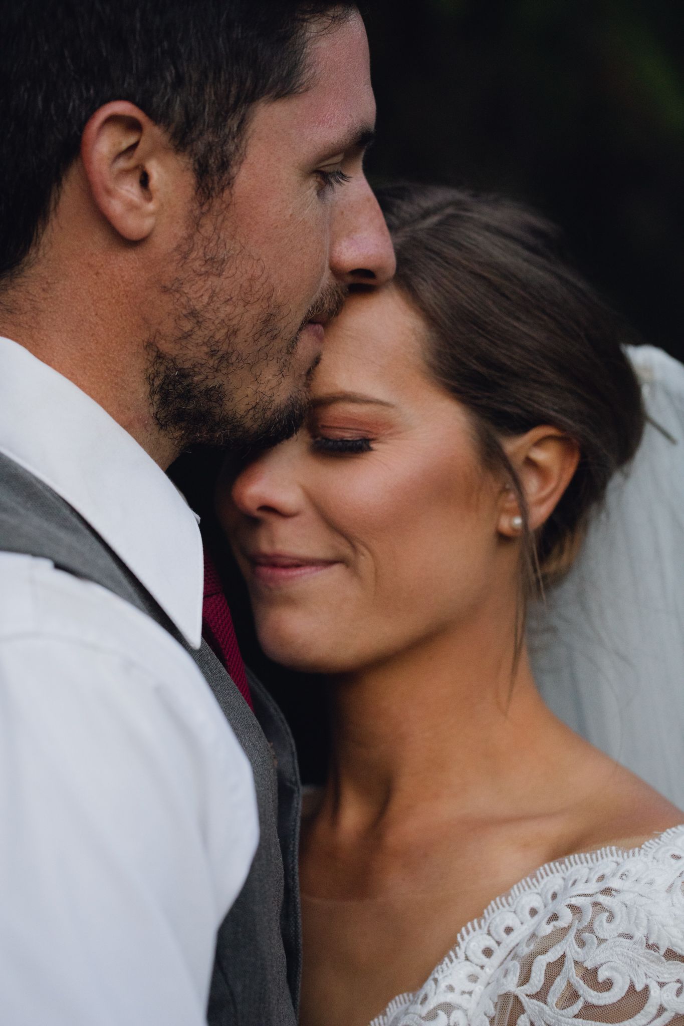 Bride and Groom snuggling in Idaho at an adventurous intimiate wedding at a camp.