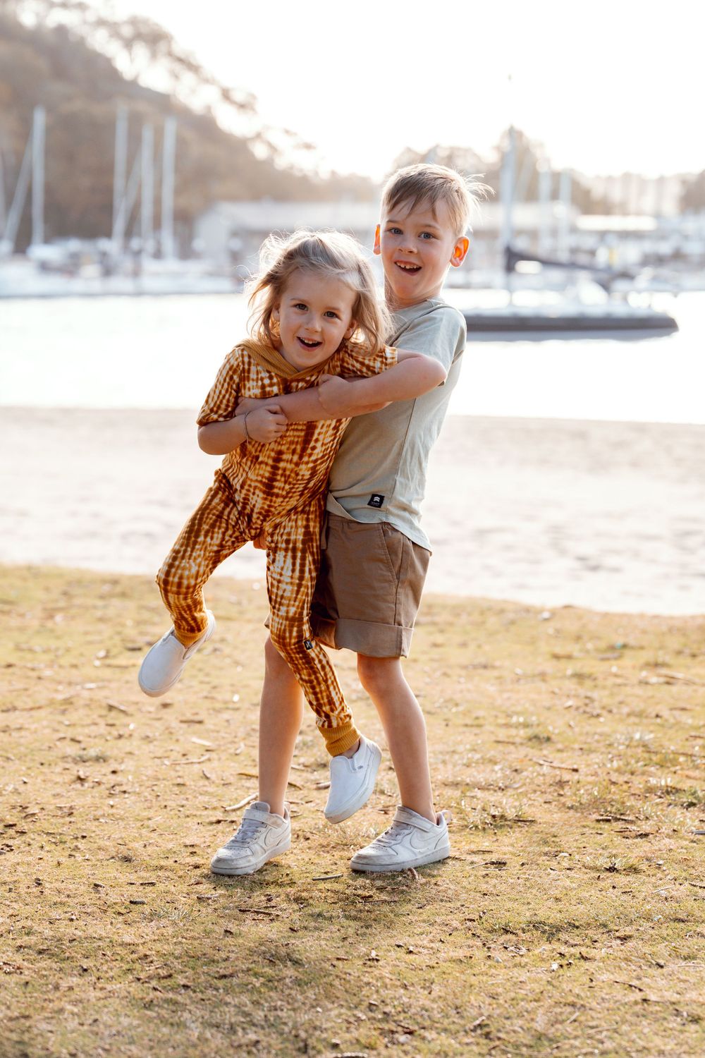 boy siblings playing during a family photoshoot at the Clontarf beach