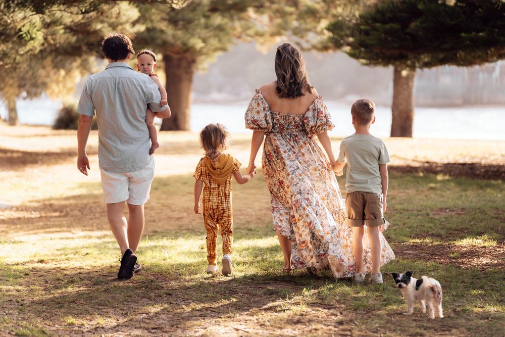 Family walking away with a dog during a family photoshoot in sydney