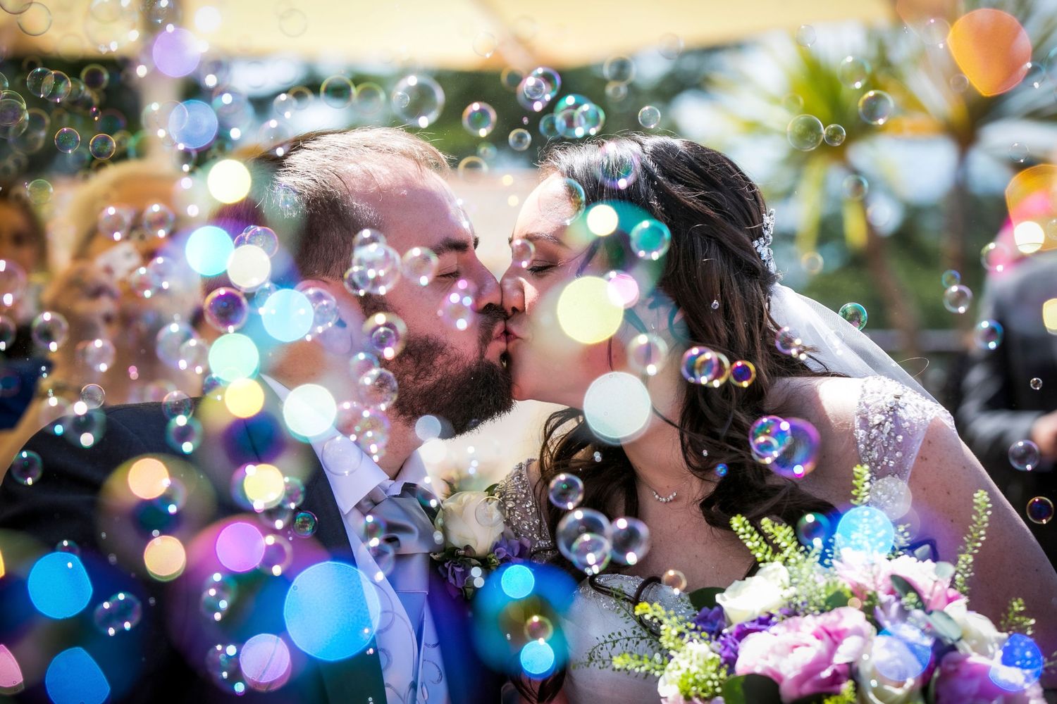 Colorful soap bubbles floating in the air creating a magical wedding atmosphere.