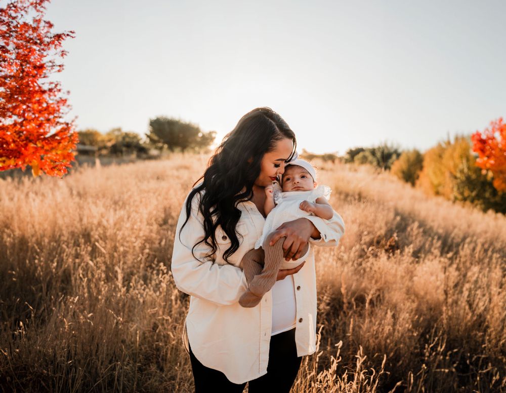 Intimate family moments captured against vibrant fall foliage and golden grass.