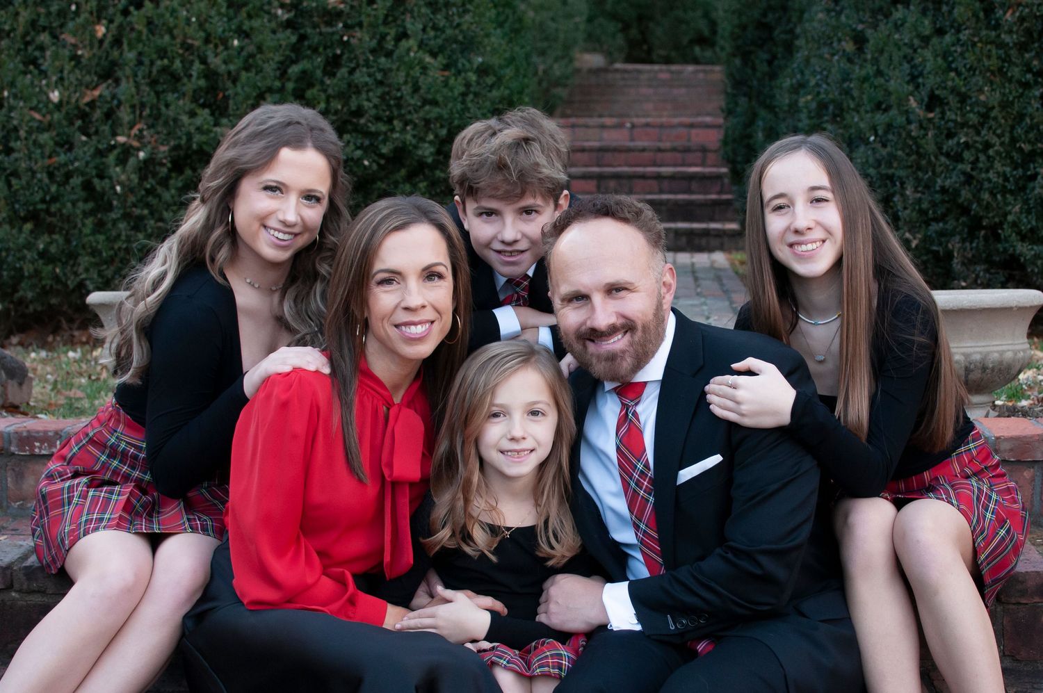 Family hugging on steps holiday photo
