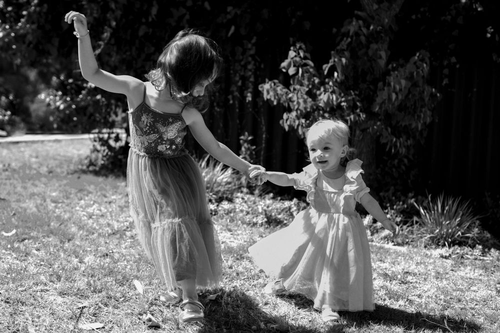 Two sisters dancing in their front yard