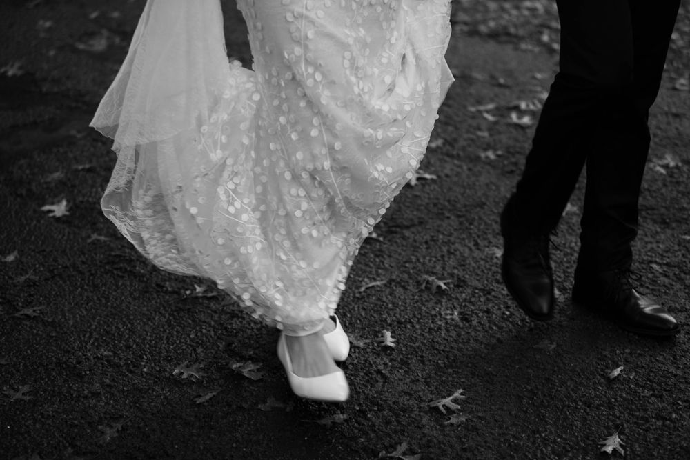 bride and groom portrait of their shoes while their walking