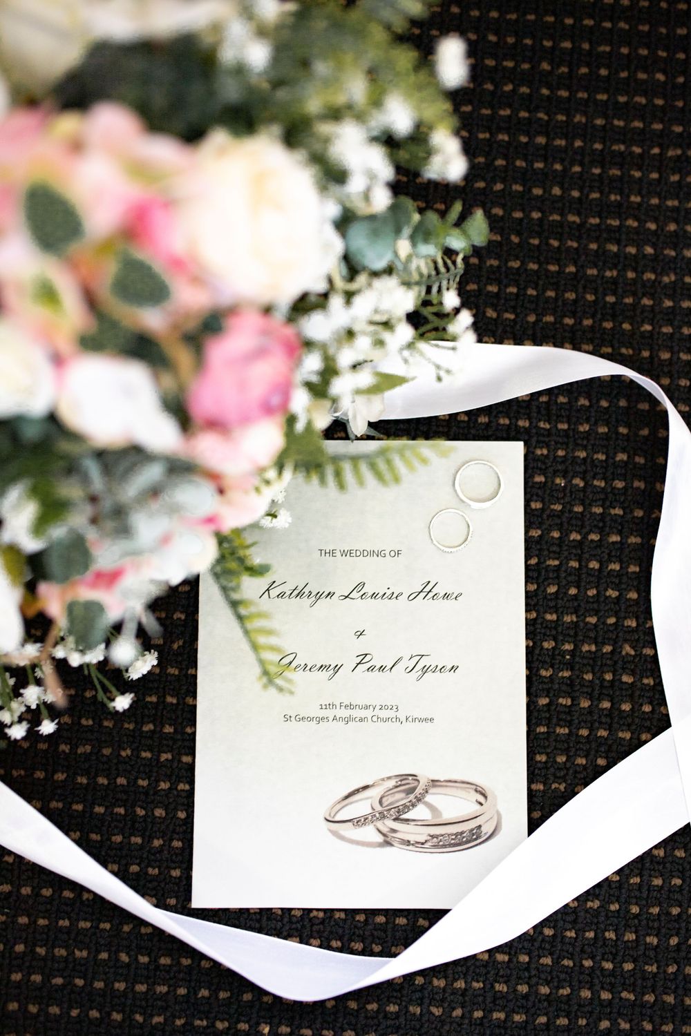detail photograph of wedding invitation bouquet and rings