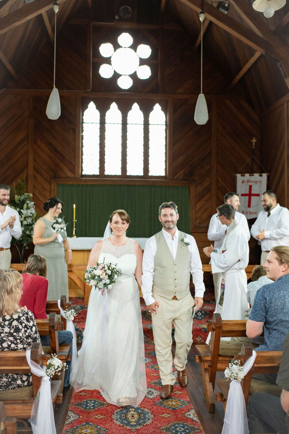 bride and groom portrait walking together through church