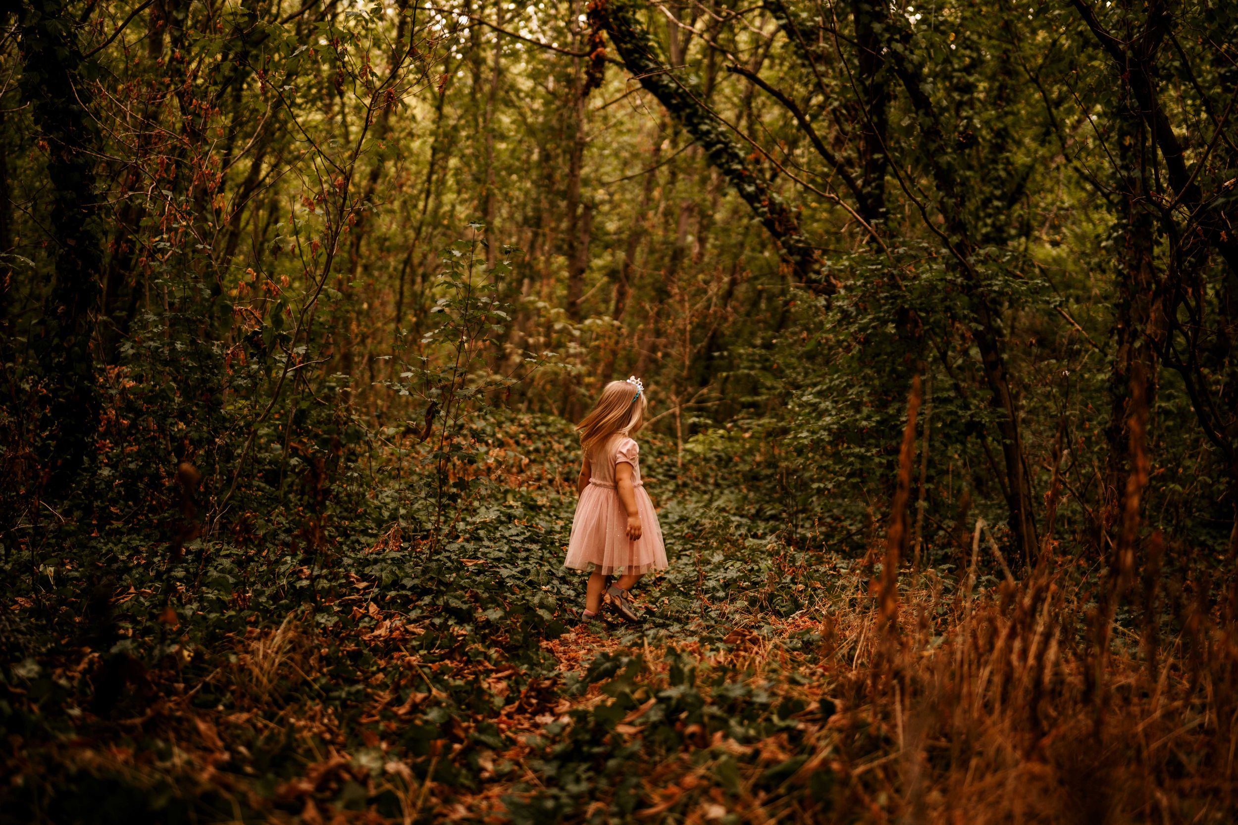 An ethereal scene of a pink dress flowing through a mystical forest setting.