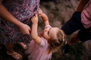 A playful candid moment captured from above during an outdoor family photoshoot.