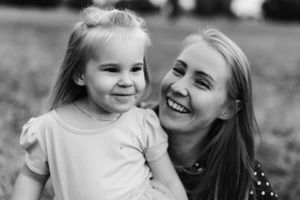 A joyful black and white portrait captured outdoors with natural expressions and genuine smiles.