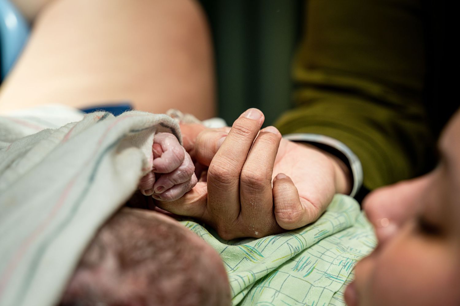 A tender moment captured in low light showing an emotional connection.