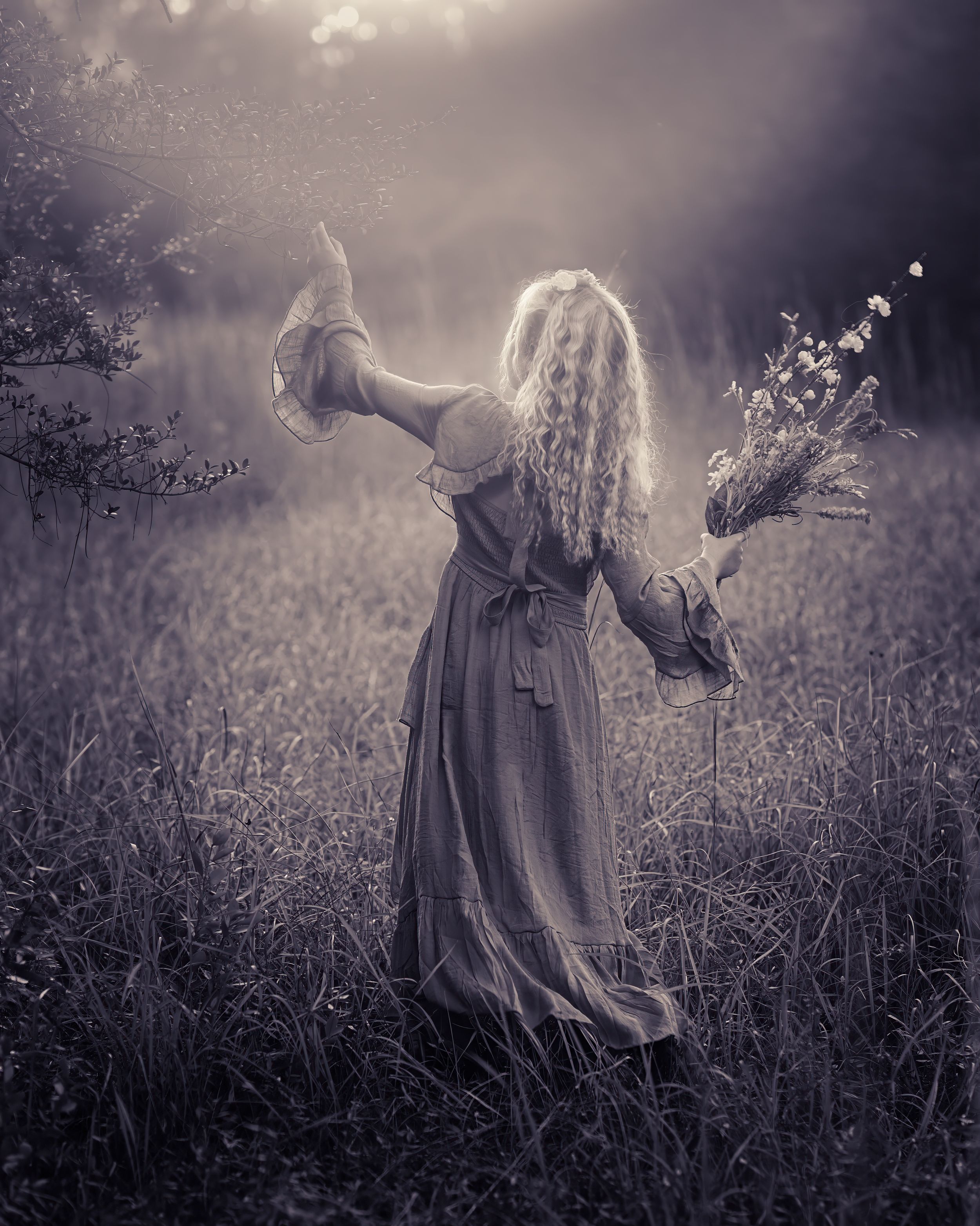 Duotone Portrait of Girl with Flowers in Field