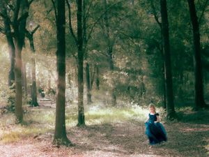 Painterly Portrait of Little Girl in Blue Dress Running through Woods