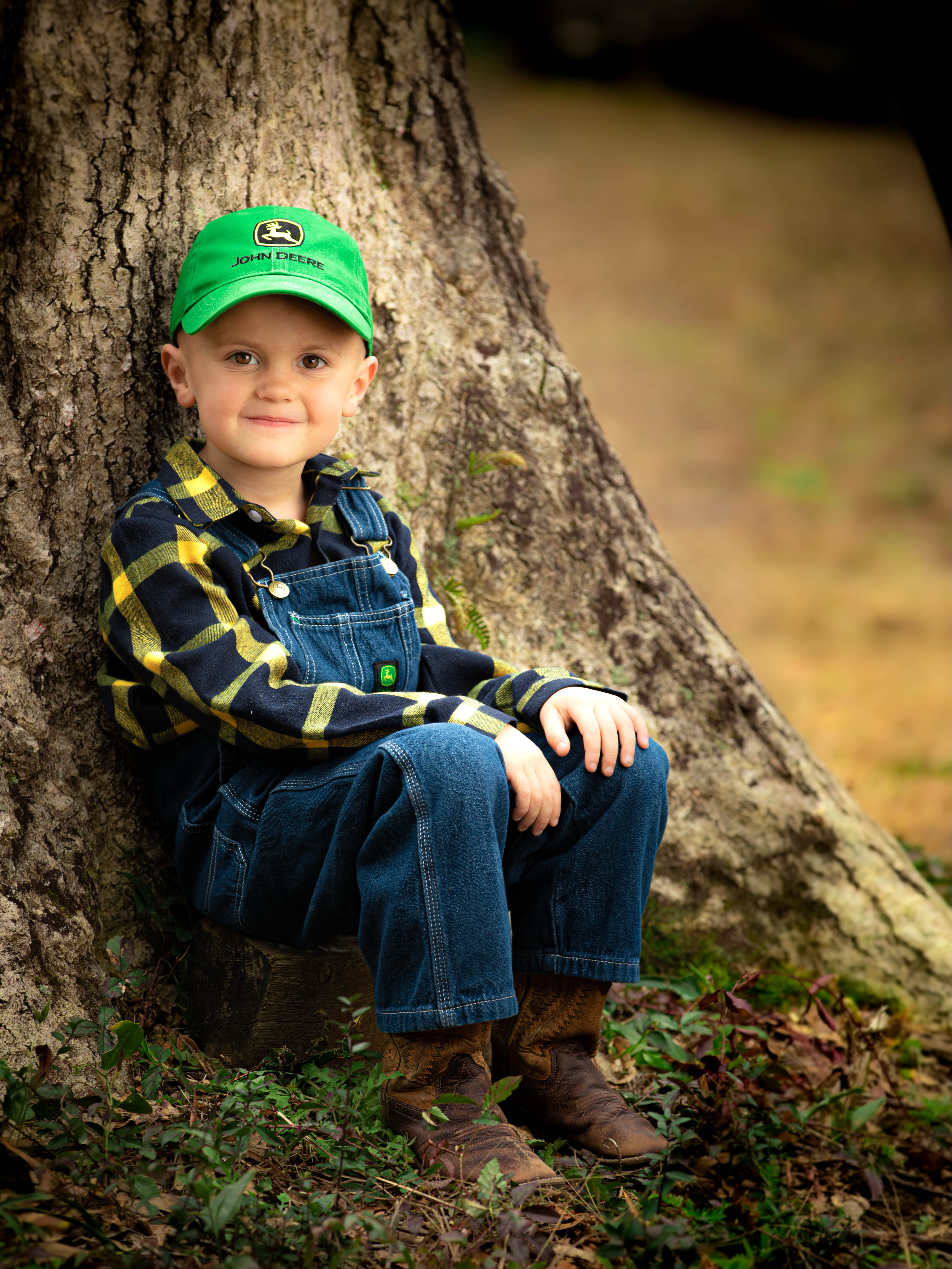 Five Year-old Boy in John Deere Hat by Tree Stump Portrait