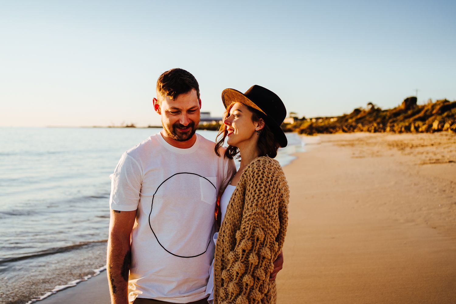 A man and woman embracing on the beach