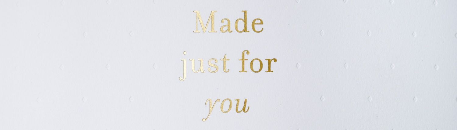 Gold foil text reading 'Made just for you' printed on white paper or card stock.