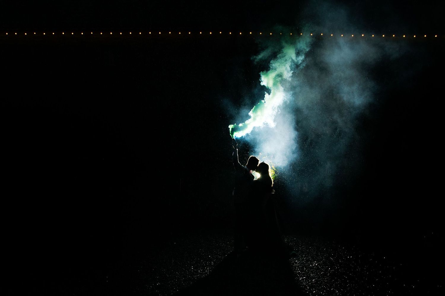 Fireworks display lighting up night sky with smoky effects.