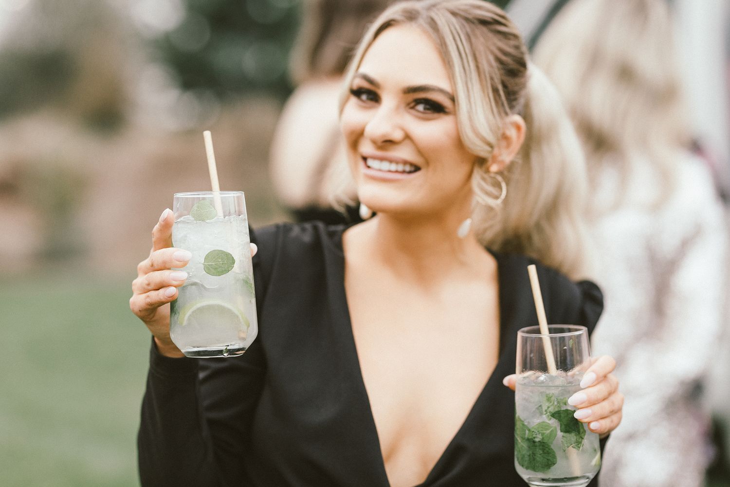 Guests enjoying cocktails at an elegant outdoor reception.