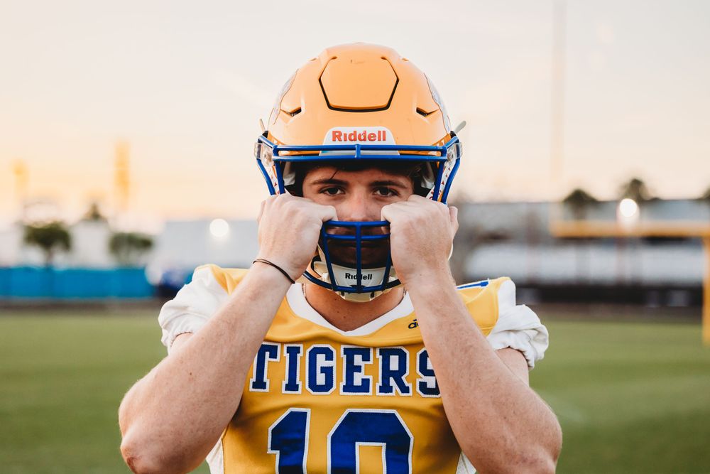 Senior boy commemorating his days in high school football