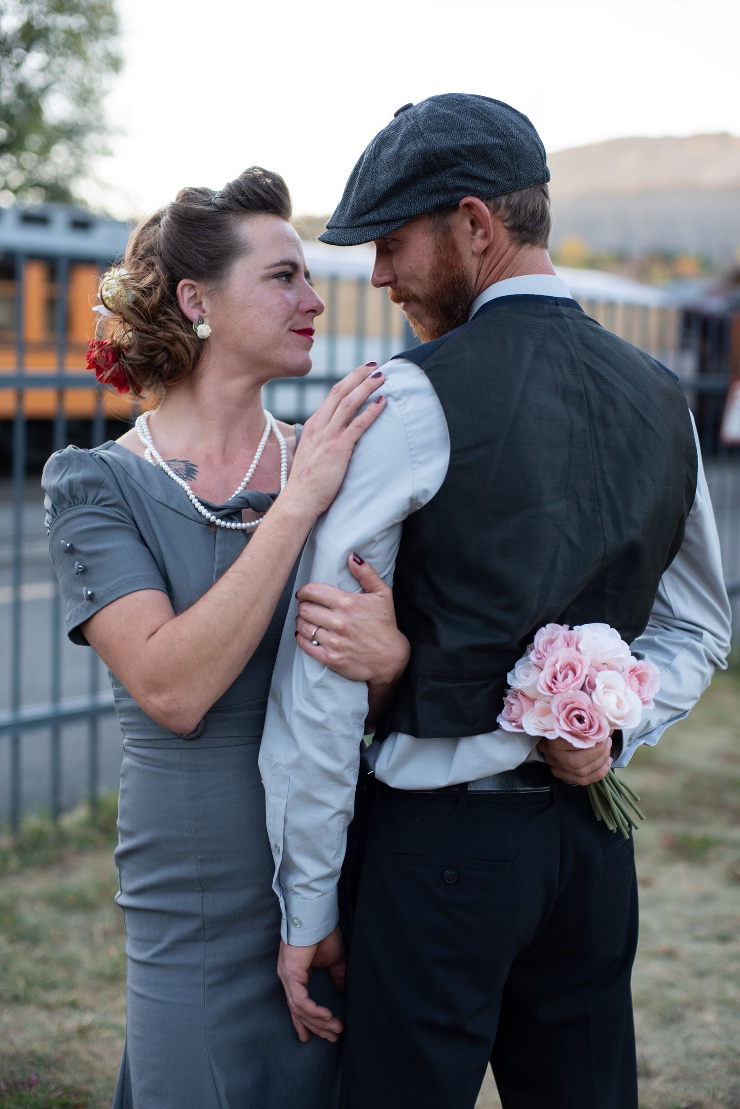 Engaged couple posing with flowers