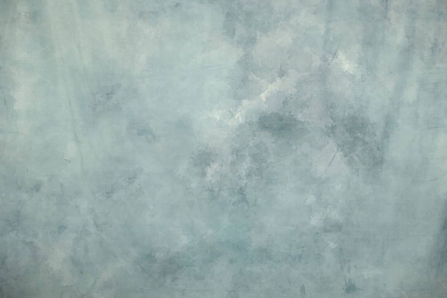 Mottled gray and blue watercolor background with cloudy abstract texture.