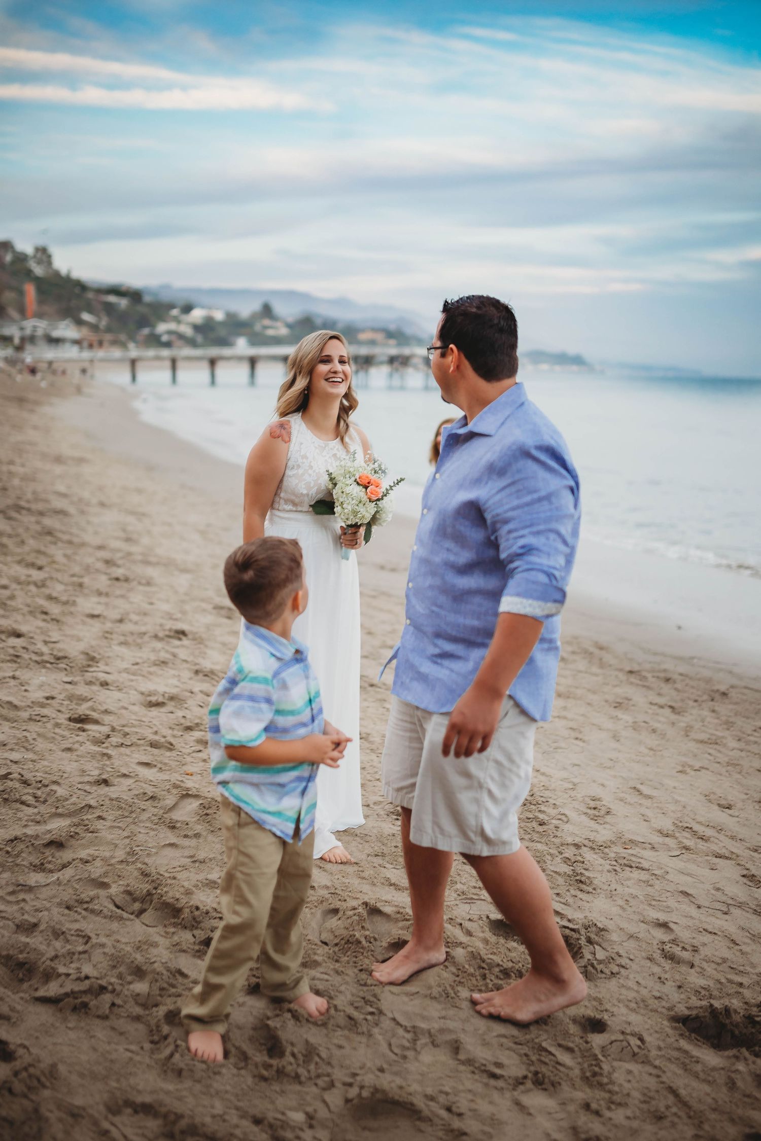bride and groom on a beach during their first look before getting married