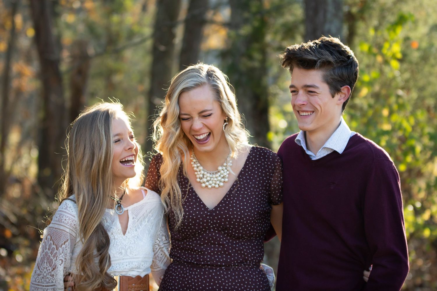 Family portrait outdoors with autumn trees and natural lighting in background. Family Photography Batavia Cincinnati Ohio